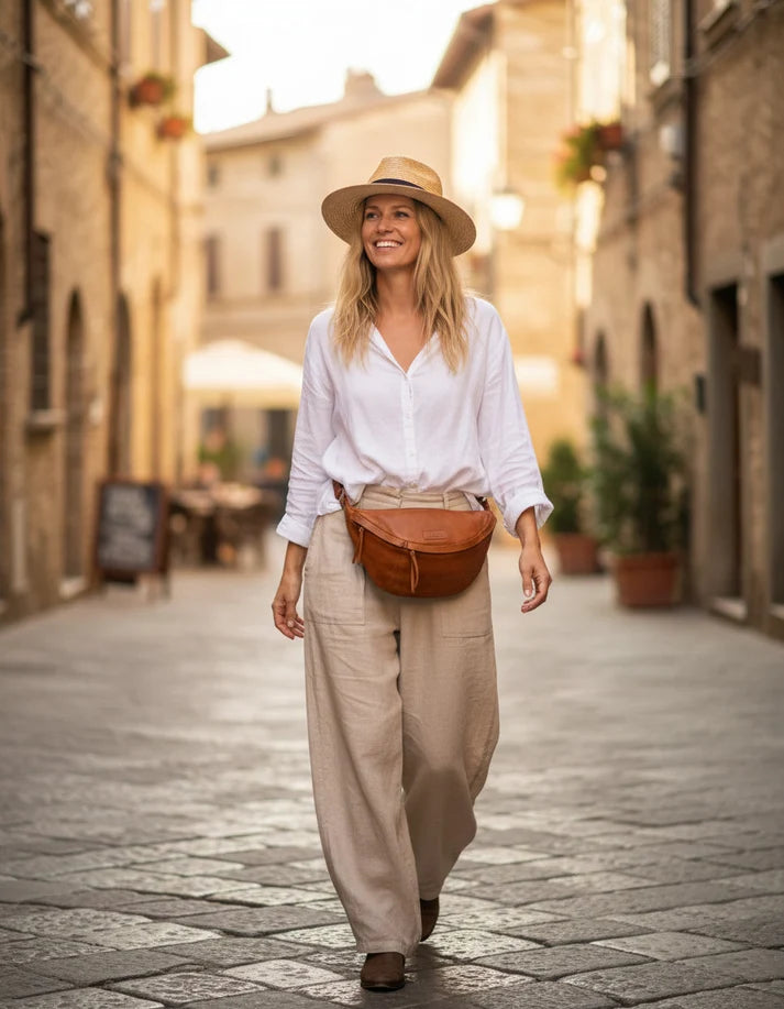 Brown cognac women's leather waist bag worn on the hip during a walk