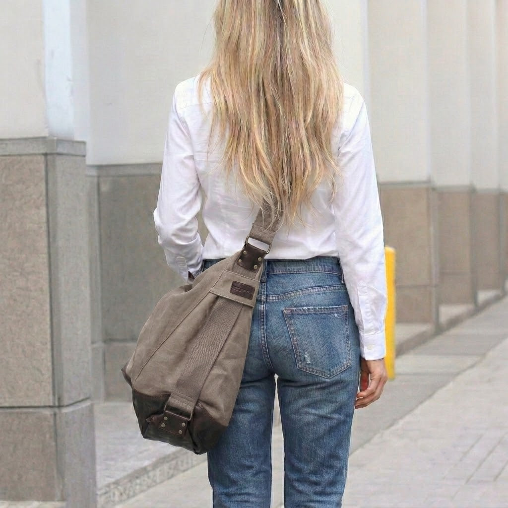 Women's canvas SAFFI HOBO bag worn crossbody. Canvas bag