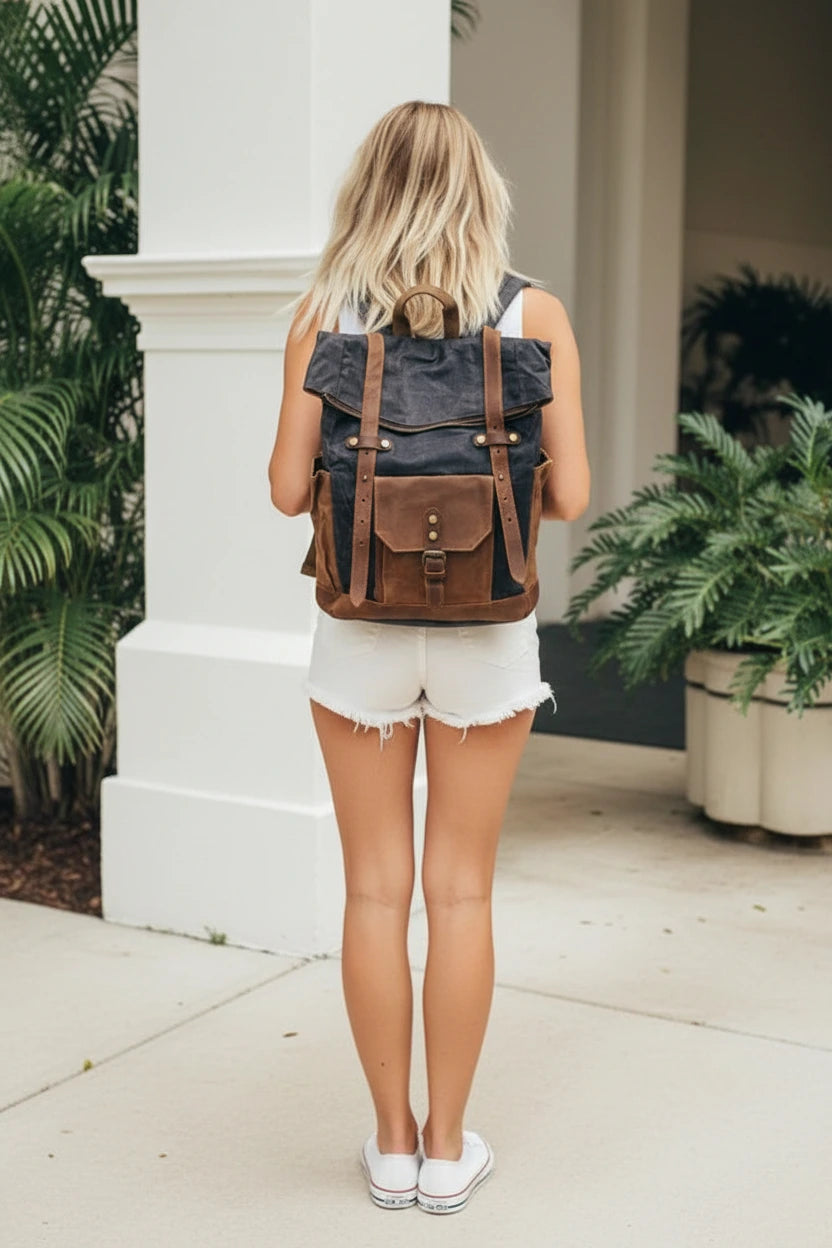 Woman with a large roll-top backpack made of cotton canvas in a casual outfit